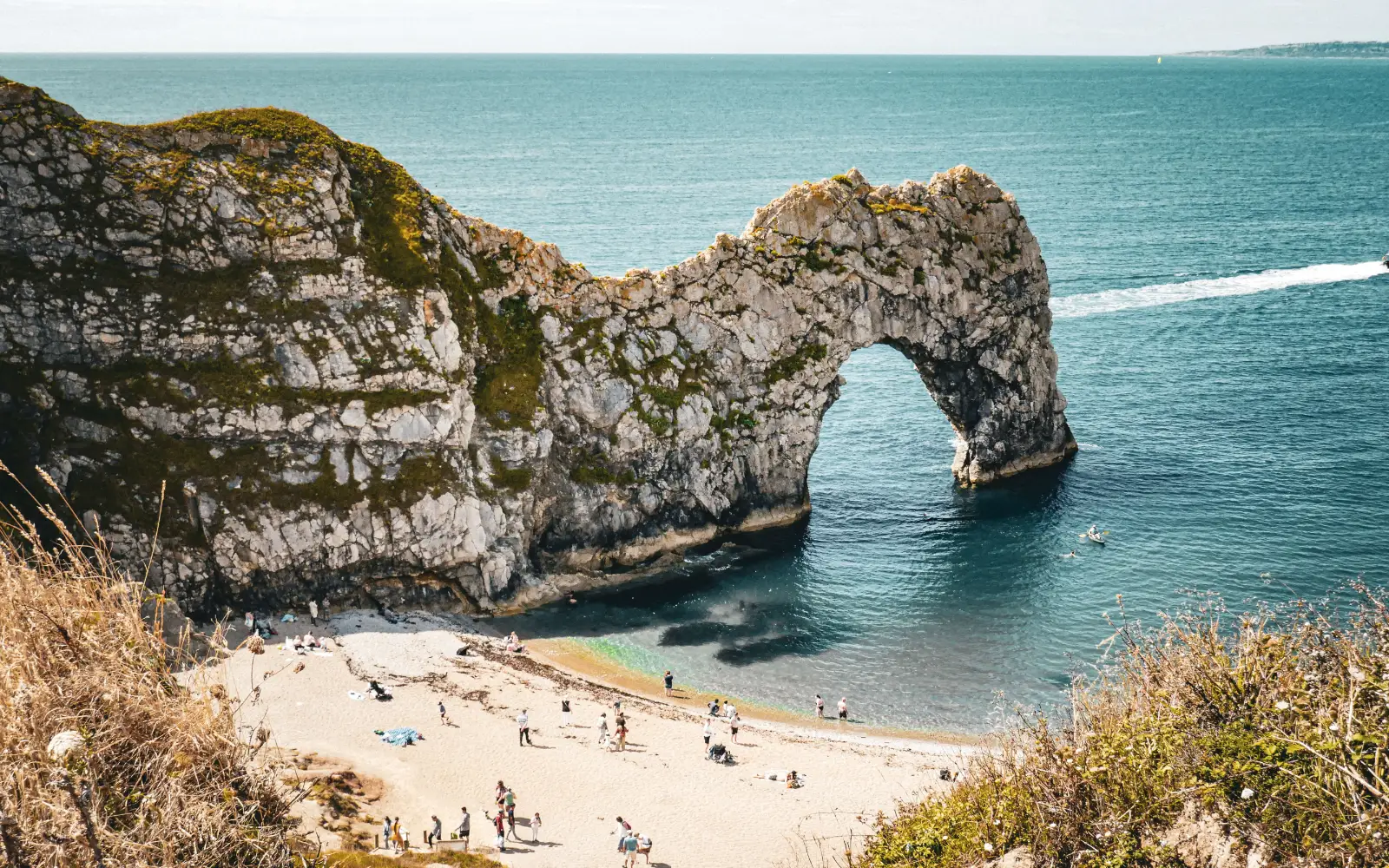 Summer scene at Durdle Door, a natural limestone arch on the Jurassic Coast of England